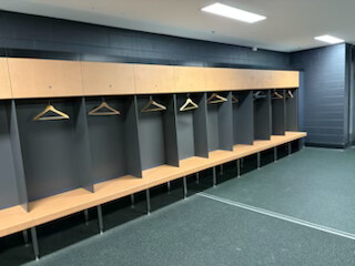 Brisbane Roar FC changeroom — lockers and benches